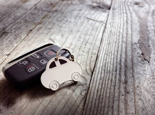 A car key chain with a remote on top of it.